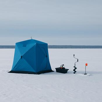 Mid-lake ice fishing kit with sled and two rods lined up