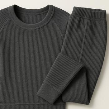 Base layer panel with thermal top and leggings laid on dark background