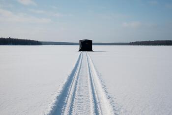 Single ice shelter and walking track leading to mid-lake holes
