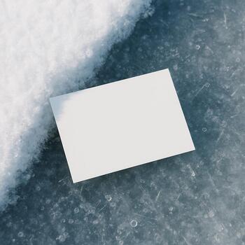 Small note card resting on the edge between snow and clear ice