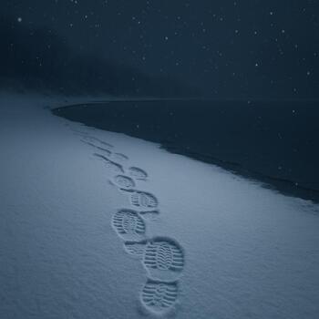 Snowy night return with overlapping boot prints near shore