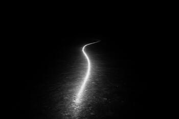 Night return line marked only by headlamp glow on the ice path