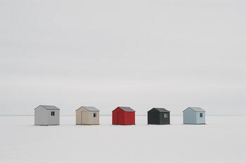 Row of ice shelters sitting on thick midwinter ice