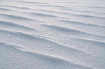Snow flags and drifts forming small ridges across the ice