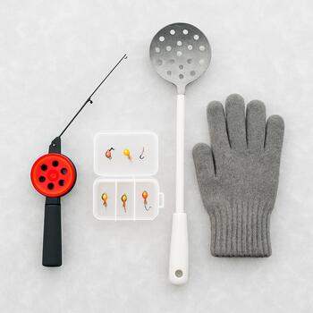 Flatlay of a compact ice rod, reel, small tackle box and foldable stool on blue ice
